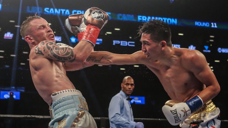 Leo Santa Cruz of Mexico (gold trunks) fights Carl Frampton of Northern Ireland (blue trunks)