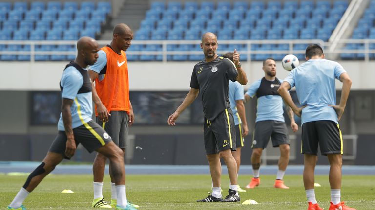 Pep Guardiola (centre) is preparing to lead Man City in his first Premier League campaign