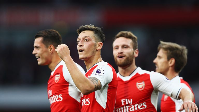 Mesut Ozil (C) celebrates scoring Arsenal's third