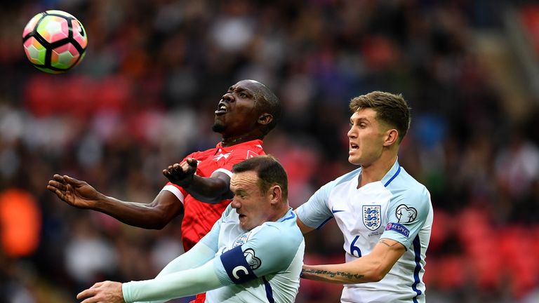 Malta's Alfred Effiong controls the ball under pressure from Wayne Rooney and John Stones 