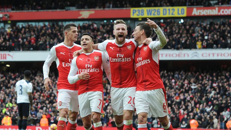 Arsenal players celebrate after Kevin Wimmer's own goal at the Emirates