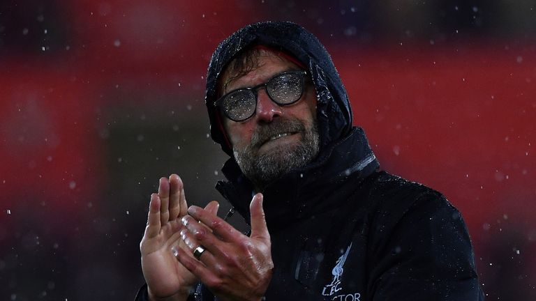 Rain covers the glasses of Liverpool's German manager Jurgen Klopp as he applauds the fans 