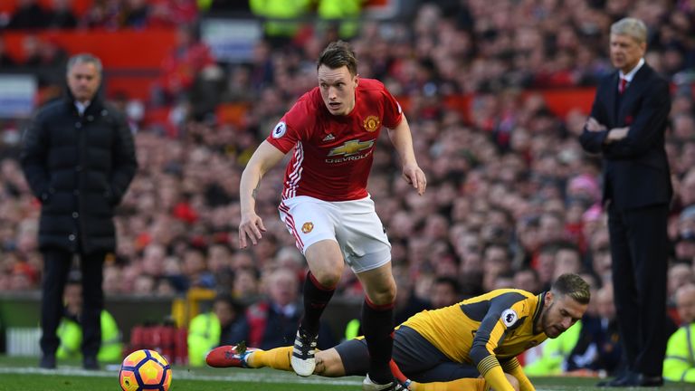 Manchester United defender Phil Jones (L) vies with Arsenal's Aaron Ramsey 