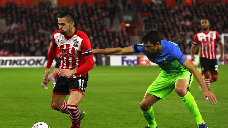 Andrea Ranocchia of Inter puts pressure on Dusan Tadic