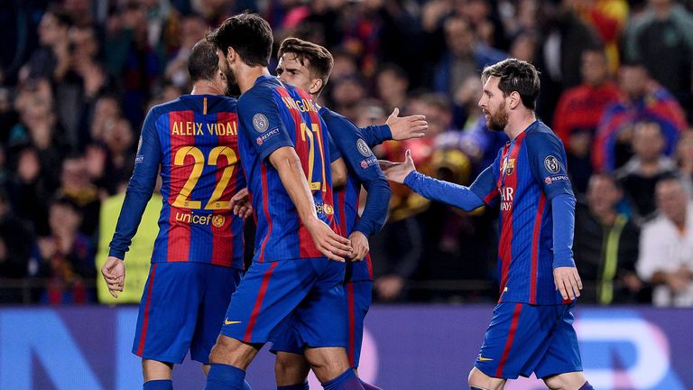 Barcelona forward Lionel Messi (R) is congratulated by his team-mates