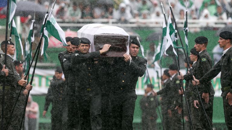 Air Force troops carry the coffin of one of the victims