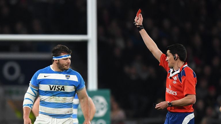 Referee Pascal Gauzere shows Enrique Pieretto a red card during the defeat to England
