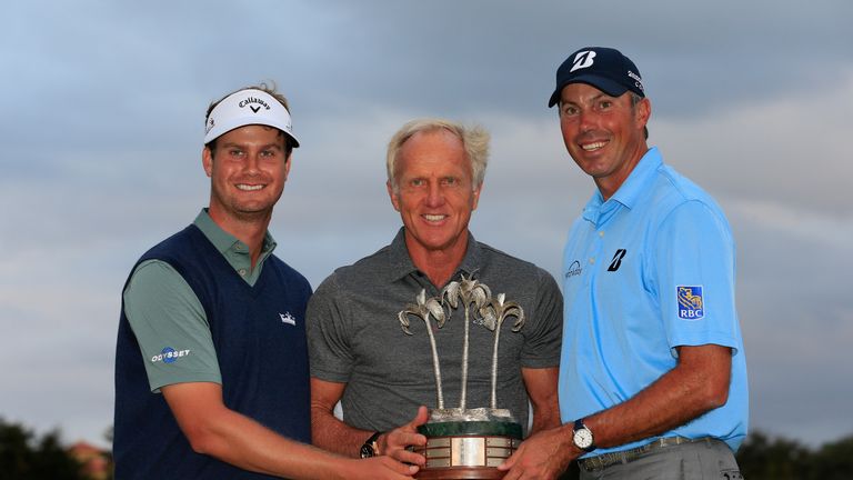 Harris English (left) and Matt Kuchar (right) are presented with their trophy by tournament host Greg Norman