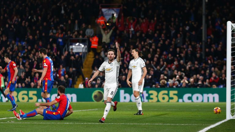 Manchester United midfielder Juan Mata gestures at the assistant referee 