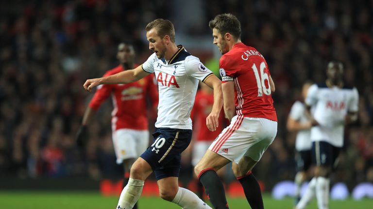 Harry Kane and Michael Carrick battle for the ball at Old Trafford