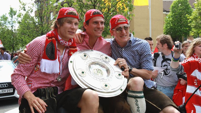 Gomez (centre) celebrates winning the Bundesliga alongside Bastian Schweinsteiger (right) and Holger Badstuber