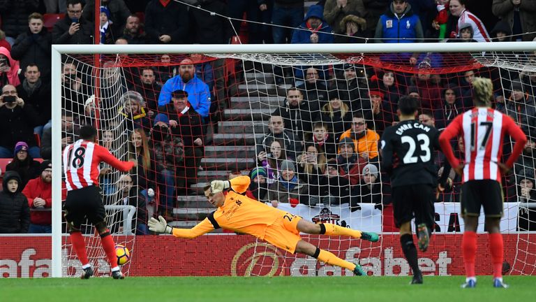 Jermain Defoe of Sunderland (L) scores from the spot to draw the home side level against Liverpool