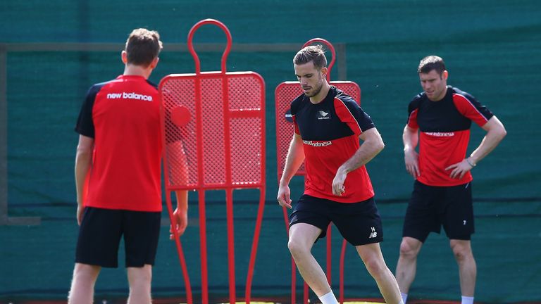 Liverpool captain Jordan Henderson (centre) may not play again this season due to an ongoing heel problem