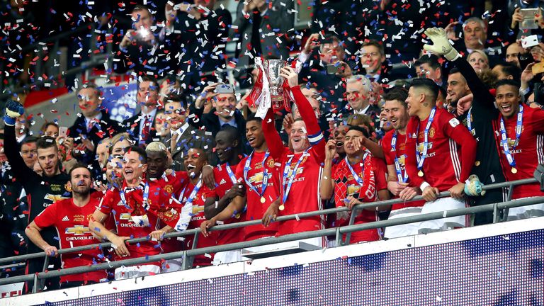 Wayne Rooney lifts the EFL Cup at Wembley Stadium