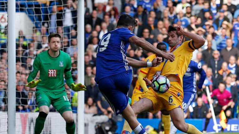 Scott Dann (right) blocks an attempt from Diego Costa