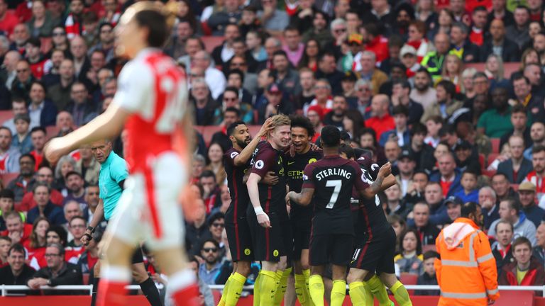 Man City celebrate after Leroy Sane's opening goal at the Emirates