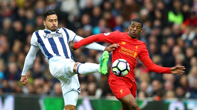 Nacer Chadli and Georginio Wijnaldum of Liverpool battle for possession