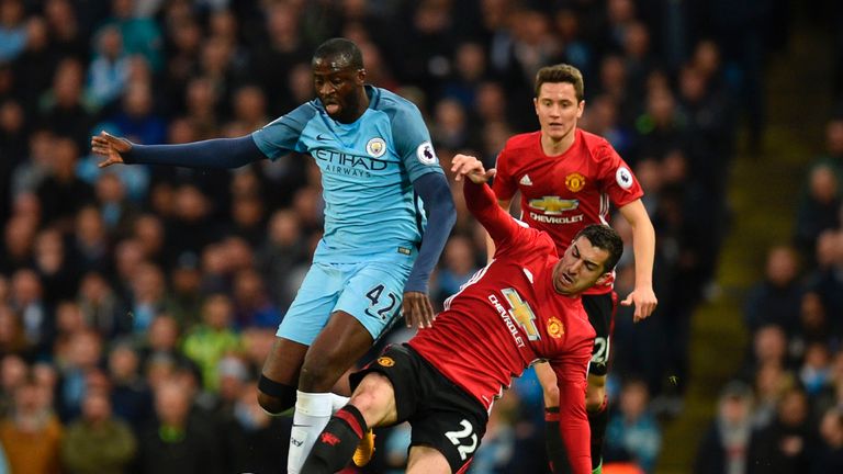 Yaya Toure (left) rides the challenge of Henrikh Mkhitaryan