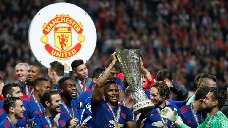 Manchester United's players celebrate with the trophy after winning the Europa League final against Ajax