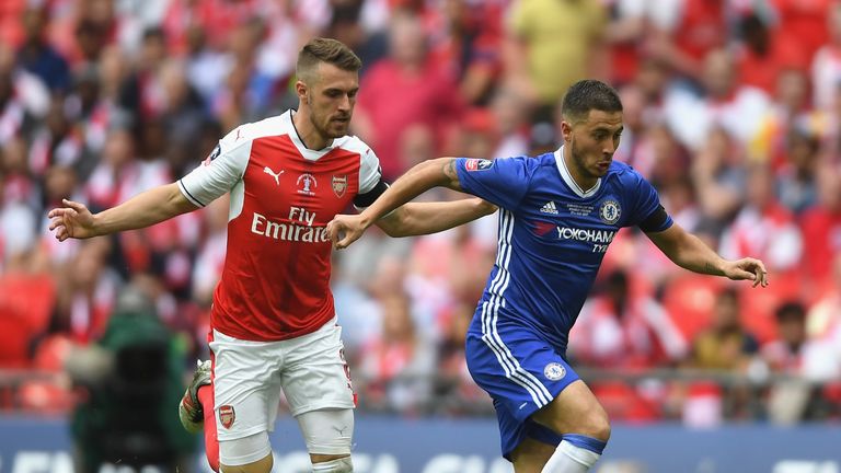 Eden Hazard of Chelsea is chased down by Aaron Ramsey 