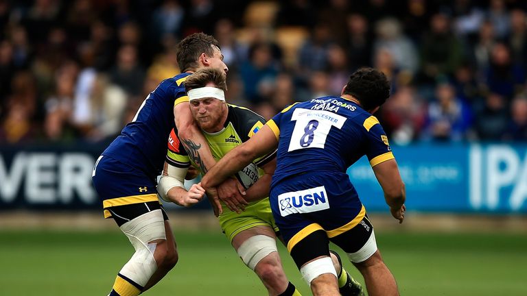 Brendon O'Connor of Leicester is tackled by Ryan Mills (L) and Marco Mama (R) of Worcester