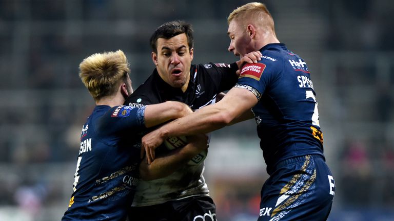 Corey Thompson of Widnes is tackled by Danny Richardson and Jake Spedding