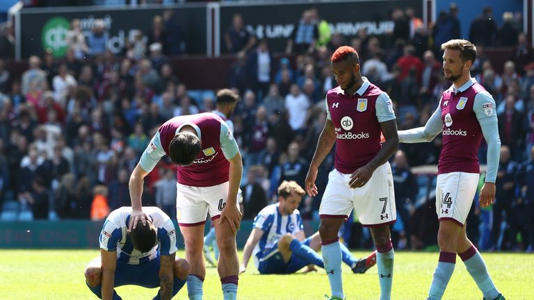 Brighton players are consoled after throwing away the title in the final minutes of the season