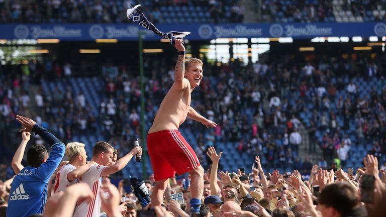 Former Tottenham midfielder Lewis Holtby leads the Hamburg celebrations