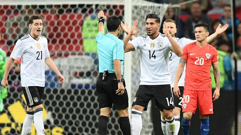 Germany's midfielder Emre Can argues with the referee