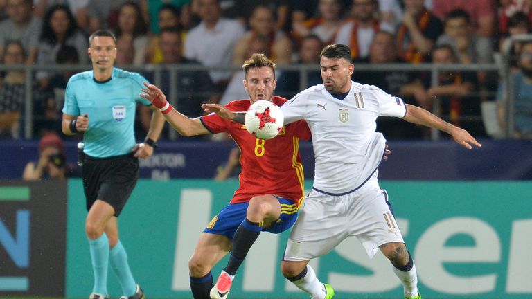 Saul Niguez of Spain challenges for the ball with Andrea Petagna of Italy