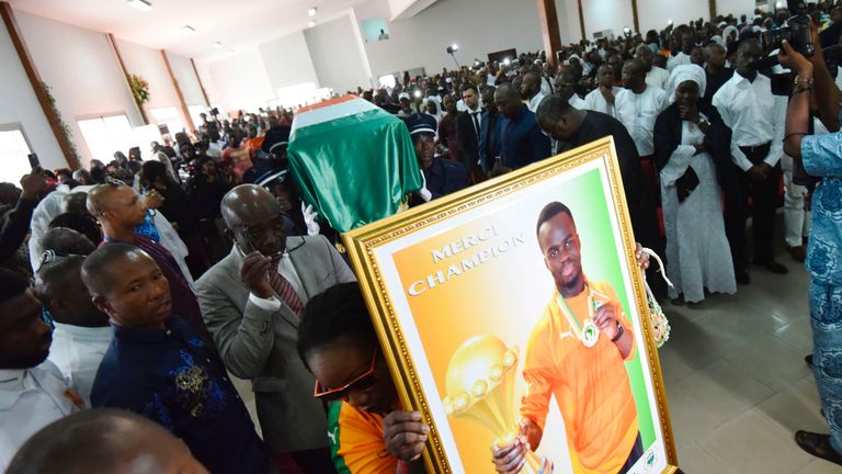 Pallbearers carry the coffin of football star Cheick Tiote during his funeral