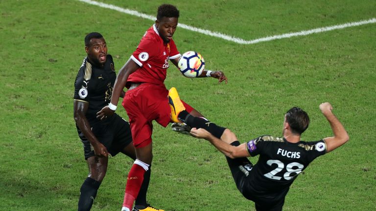Divock Origi battles for the ball with Wes Morgan and Christian Fuchs in Hong Kong