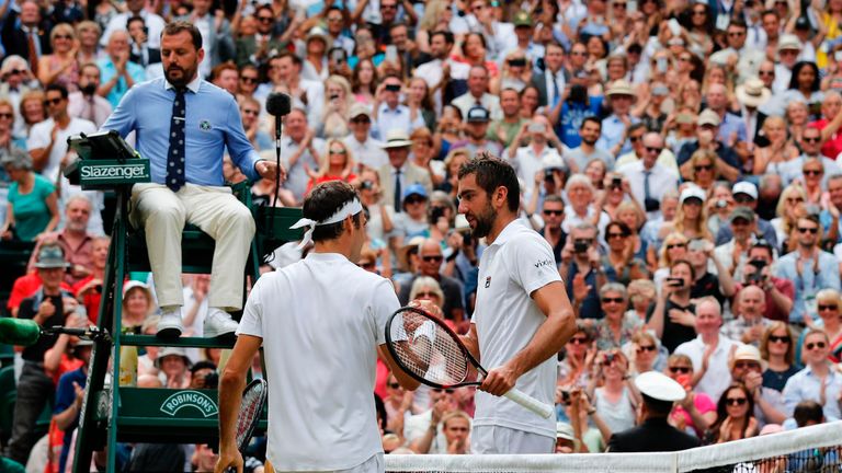Federer shakes hands with Cilic after winning the final