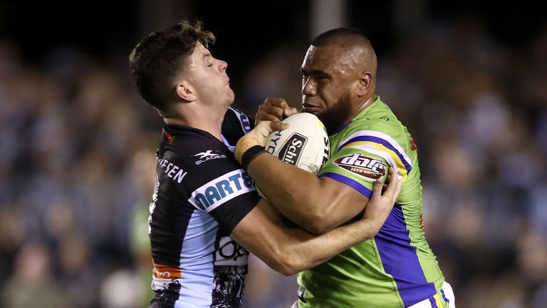 Chad Townsend (L) tackles Junior Paulo (R)
