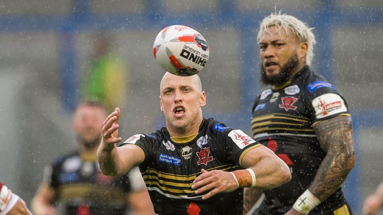 Salford's Michael Dobson struggles to control the ball in the rain in what has been a testing couple of months on the field for the club