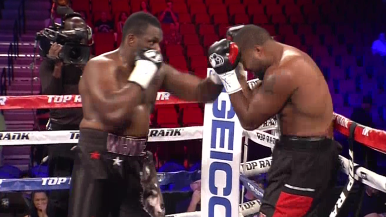 Dillian Whyte forces Malcolm Tann back on to the ropes 
