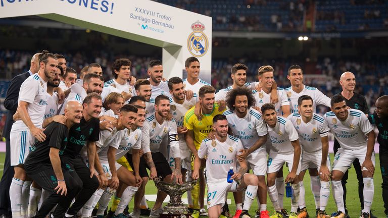 Real Madrid players celebrate with the Santiago Bernabeu trophy