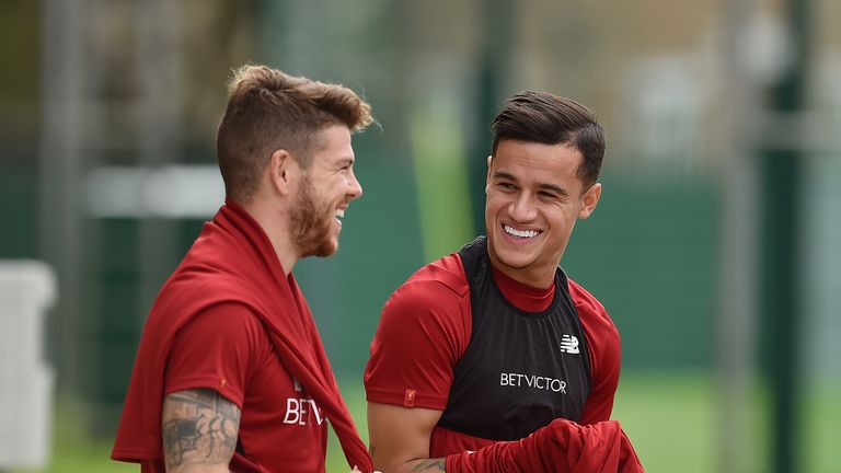 Philippe Coutinho laughs with Alberto Moreno after returning to Liverpool training