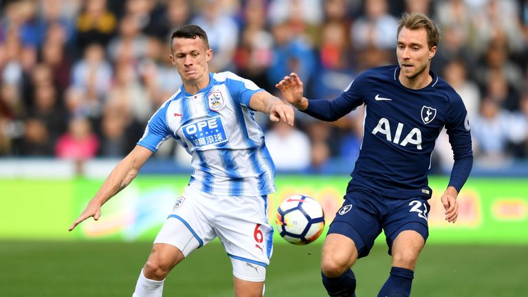 Jonathan Hogg of Huddersfield Town and Christian Eriksen of Tottenham Hotspur battle for possession