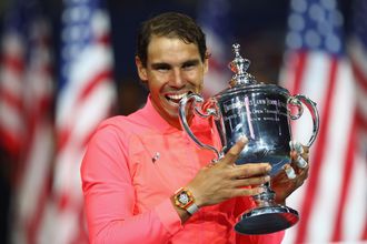 Rafael Nadal of Spain bites the championship trophy