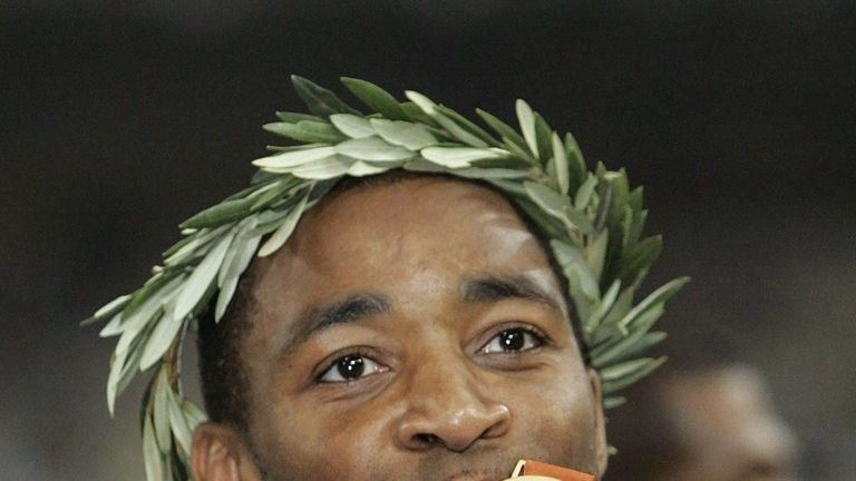 Darren Campbell kisses his gold medal after winning relay gold at the 2004 Athens Olympics