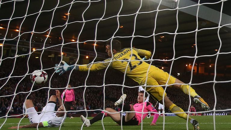 Martin Skrtel watches on as his attempted block of Anya's cross ends up going into the net