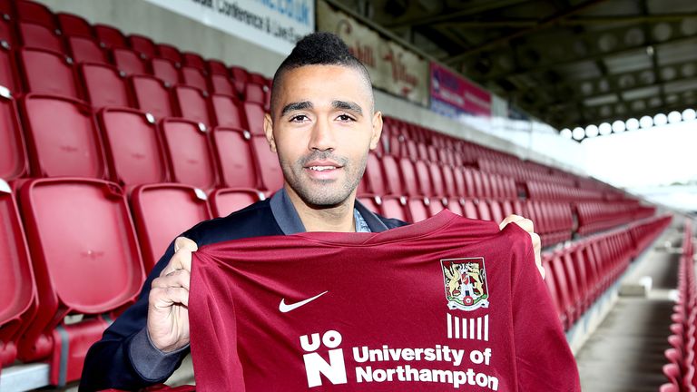 Lewis McGugan poses with a shirt during a photo call at Sixfields