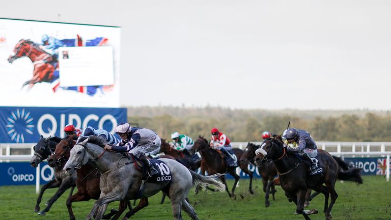 Lord Glitters (pink/blue) wins the Balmoral Handicap Stakes at Ascot