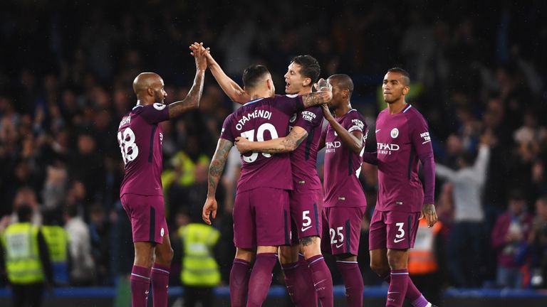 Man City's players celebrate their crucial win at Stamford Bridge