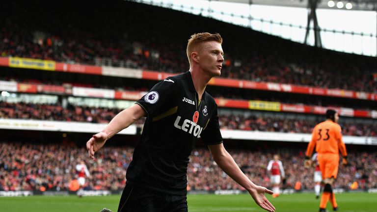 Sam Clucas celebrates scoring the opening goal at the Emirates Stadium