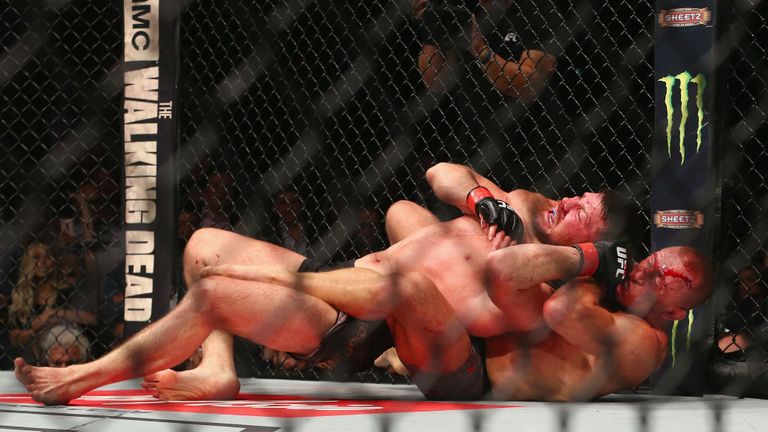 Georges St-Pierre chokes out Michael Bisping to win UFC middleweight title