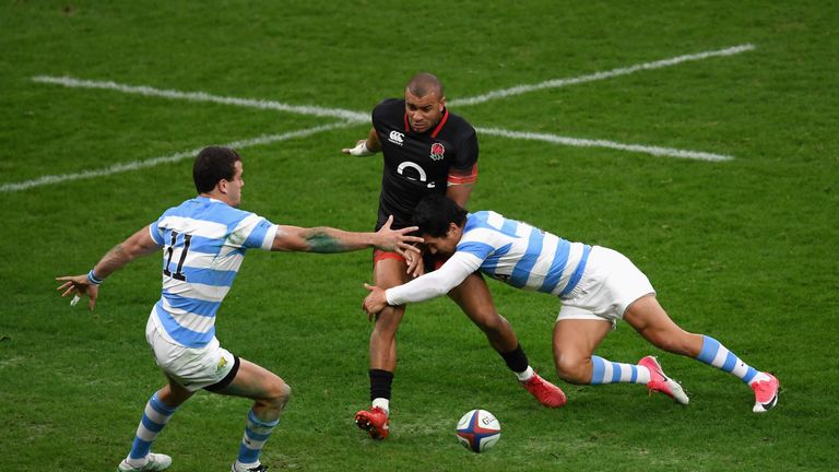 Jonathan Joseph dinks the ball ahead as he is tackled by Emiliano Boffelli