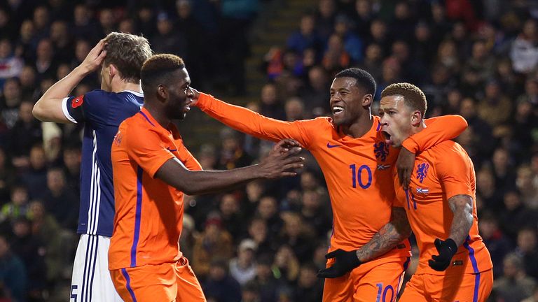 Memphis Depay (R) celebrates scoring the only goal of the game with Liverpool's Georginio Wijnaldum