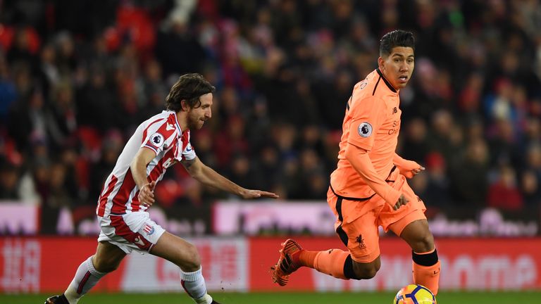 Roberto Firmino takes the ball away from Joe Allen